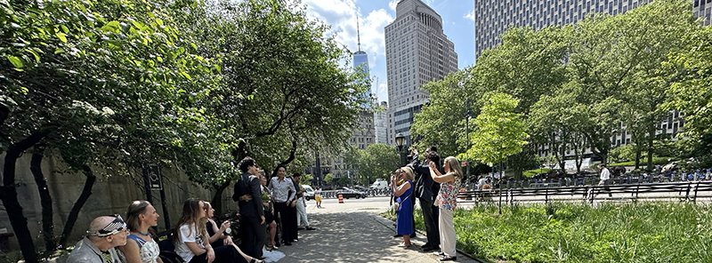 Couples exchanging vows in front of the New York City Marriage Bureau. One Stop Translations provides fast and accurate translation services for marriage documents needed for visa and dual passport applications, delivering Apostille translations within hours.